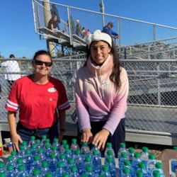 two volunteers at water station